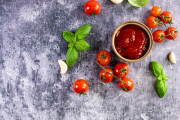 Tomato paste, sauce, ketchup and cherry tomatoes on branches and basil