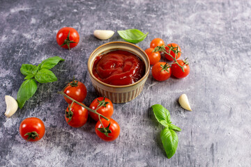 Tomato paste, sauce, ketchup and cherry tomatoes on branches and basil