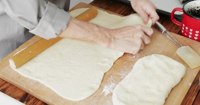 Poppy seed roll preparing, stretching dough using pin roller