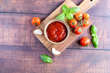 Tomato paste, sauce, ketchup and cherry tomatoes on branches and basil