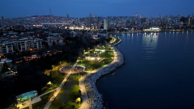 A drone flies over the evening waterfront in Moda district, Kadikoy, Istanbul, Turkey