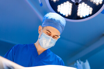 Surgeon in operating room. A skilled surgeon focuses intently on a patient during a critical...