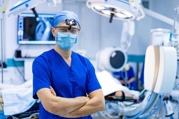 Surgeon gets ready for surgery. A confident surgical professional stands ready in an operating room filled with advanced medical equipment.