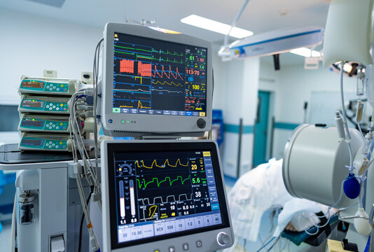Hospital patient monitoring. Medical equipment displays vital signs of patients in a hospital room.
