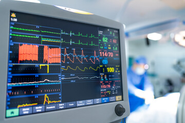 Surgical vital signs monitor. A vital signs monitor displays real-time health data while a surgical...