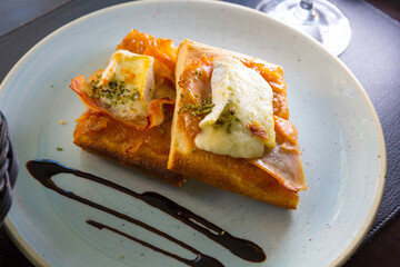 Appetizing Catalan focaccia with caramelized onion, Brie cheese and bacon..