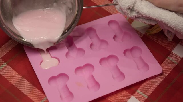 ice cream is made from melted sugar, sweet white chocolate or cream in molds for freezing in freezer in the form of small penis. Slow motion