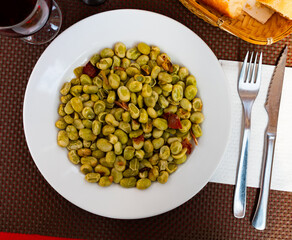 Habas a la Catalana, delicious stew of beans with slices of ham traditionally flavored with paprika ..