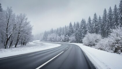 Snowy Winter Road Curves Through Forest Landscape Under Cloudy Gray Sky