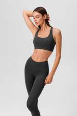 Fitness woman. Athletic girl on the gray background