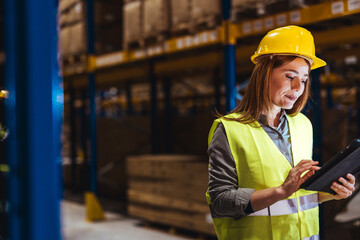 Female Warehouse Worker Using Tablet for Inventory Management Tasks