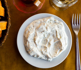 Fresh, savory and easy to make Turkish cacik, yogurt and cucumber dip with garlic and greens. Concept of popular authentic condiments ..