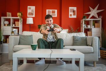 man play console video games at home hold joystick controller have fun © Miljan Živković