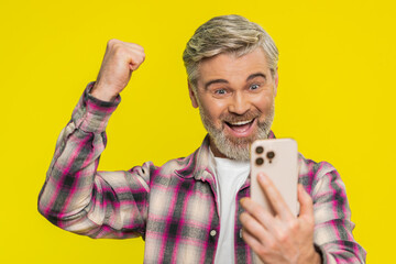 Happy excited Caucasian adult man guy use smartphone typing browsing shouting say wow yes found out...