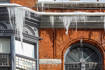 Icicles alongside red brick building