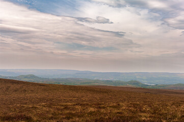 A large, open field with a cloudy sky in the background