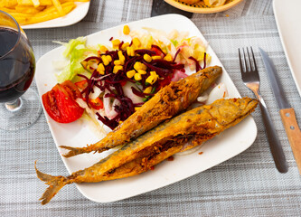 Grilled mackerel fillet served with vegetables and corn grains, seafood appetizer