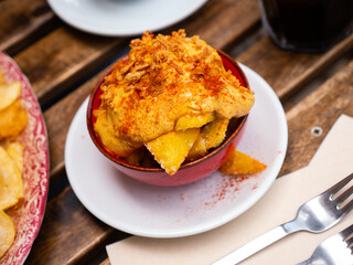 Traditional spanish snack patatas bravas with tomato sauce and mayonesse