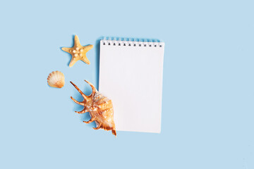 To do list or blank notebook with set of starfish, sea shell on blue background. Travel, summer...
