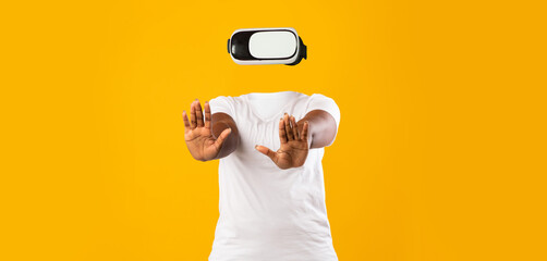 A user engages with virtual reality in a modern setting. Wearing a headset, they raise their hands,...