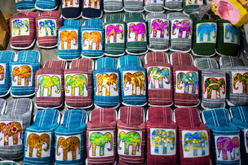 Colorful Handmade Elephant Embroidered Pouches Displayed at Luang Prabang Night Market, Laos – Traditional Lao Textile Souvenirs with Cultural Motifs