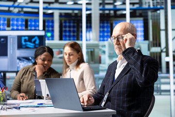 Factory engineer uses laptop to prepare presentation on research and development insights to investors. Businessman uses notebook to prepare pitch highlighting production growth opportunities