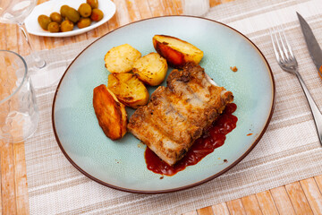 Juicy pork ribs with barbecue sauce served with potatoes