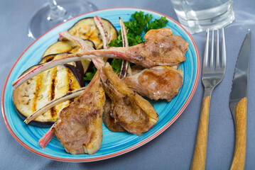Roasted mutton ribs served with baked eggplant and herbs