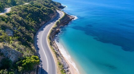 Fototapeta premium Breathtaking aerial view of coastline with winding road and sparkling blue ocean on a sunny day : Generative AI