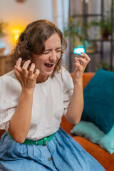 Sad woman feeling hopelessness loneliness, nervous breakdown, crying shouting sitting on sofa in...
