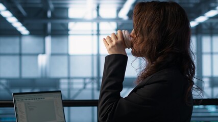 Technician using laptop in data center, finetuning network protocols, holding coffee cup. Woman in server room coding on notebook, enforcing advanced security measures, camera A