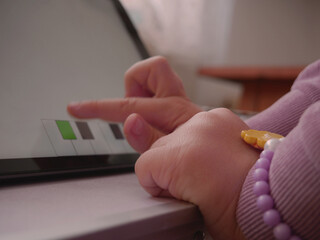 Toddler girl pushing keyboard of interactive music app.