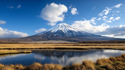 Fototapeta premium Majestic Mount Fuji Reflected in Calm Waters Under a Bright Blue Sky with White Fluffy Clouds : Generative AI