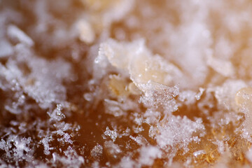 Macro shot of crystal ice form on top layer of ice cream
