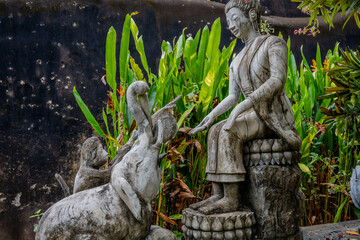 Stone Statue of Seated Figure with Elephant and Monkey at Xieng Khuan Buddha Park, Vientiane, Laos