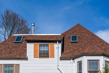 Beautiful home with brown shingle roof and skylight windows in Brighton, Massachusetts, USA
