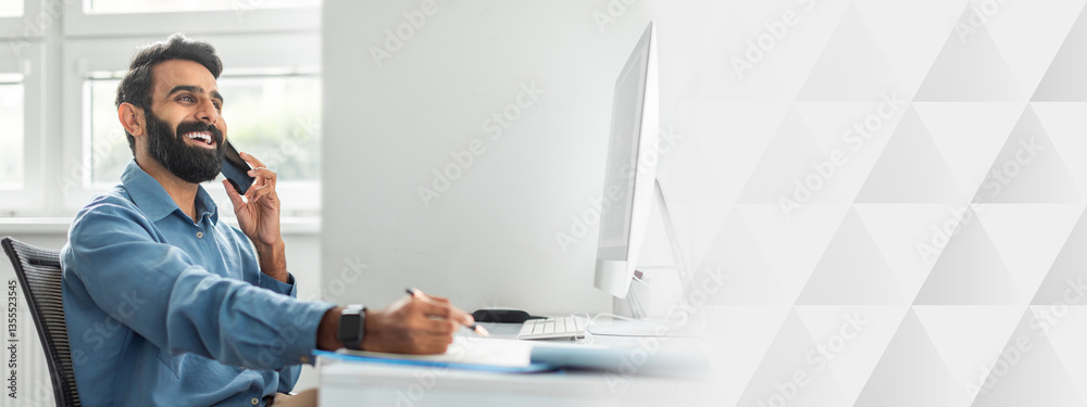 Aufkleber positive thoughtful indian businessman talking on cellphone and taking notes while working on comput