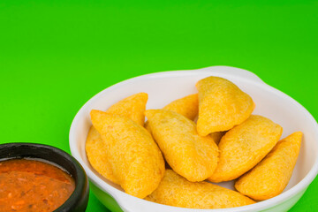 Delicious traditional Colombian empanadas with spicy sauce