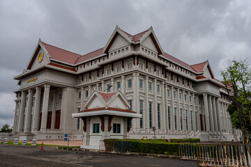 Obraz premium Imposing Government Judicial Building with Classical Columns and Traditional Lao Roof Elements in Vientiane, Laos Under Cloudy Sky
