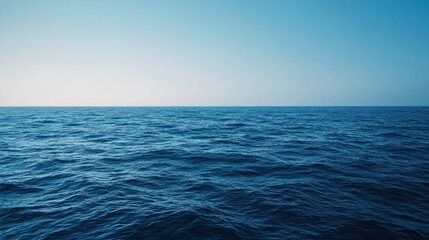 Obraz premium A serene ocean view with deep blue water and gradient effect from dark to light, evoking sense of calm and tranquility