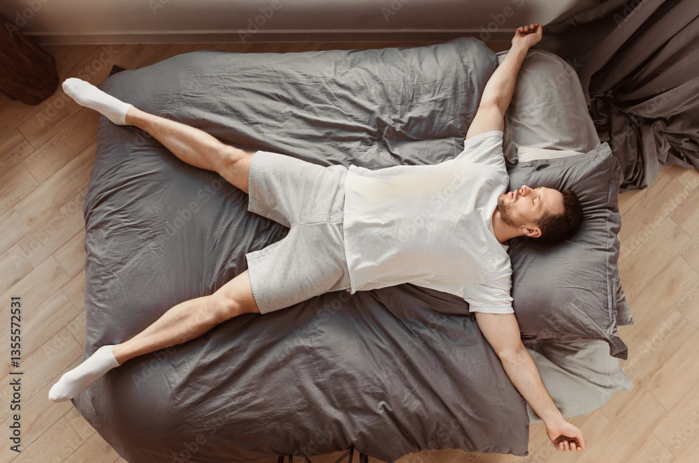 Poster fast asleep man sleeping lying on his back in bed resting at home. healthy sleep concept. top view