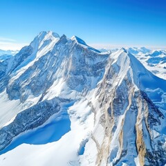 Snowy mountain peaks reach towards a vibrant blue sky; a bright, clear, and expansive view over a vast, frozen landscape