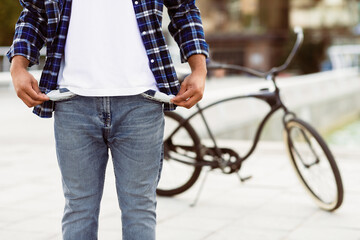 I Have No Money. Closeup of unrecognizable black man in blue casual style shirt showing his empty...