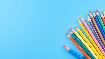Fototapeta premium Brightly Colored Pencils on Light Blue Background