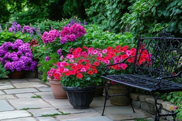 Fototapeta premium Ornamental flowers in planters, garden patio bench, lush landscaping, relaxing outdoor scene