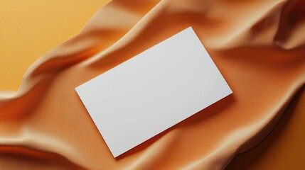 Blank business card on orange fabric