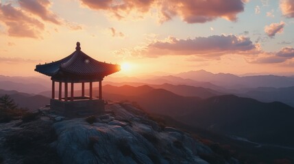 Scenic Sunset Over Mountains with Traditional Pavilion on a Hilltop in Tranquil Nature