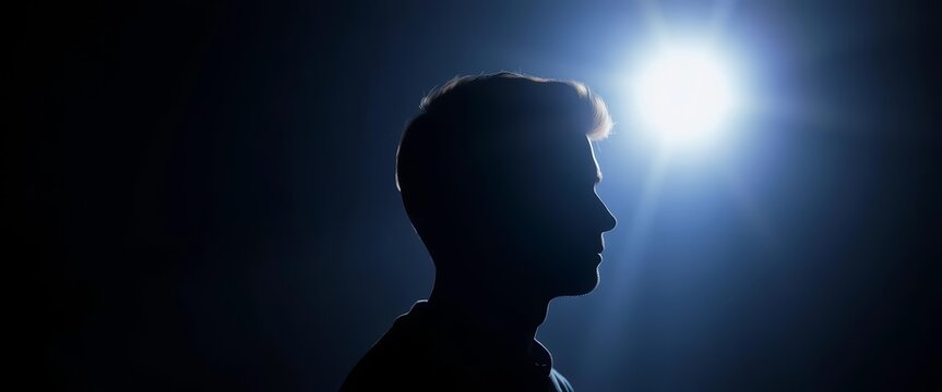 Silhouetted figure against bright light, implying manipulation, metaphor, mental manipulation