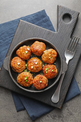 Tasty meatballs served on grey table, flat lay