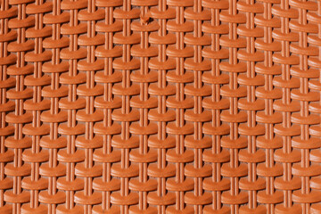 Naklejka premium Close-up of a textured, woven orange-brown surface.